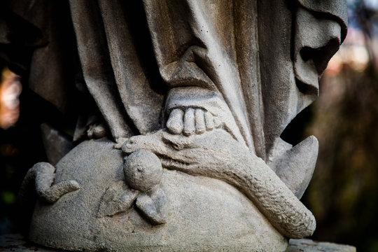 Religious symbol of Christianity: Close up Virgin Mary crushing with her foot the serpent as a symbol of the victory of good over evil.