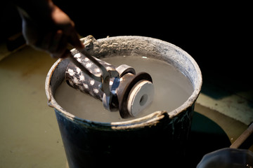 cooling hot cast mold in water after metal melting