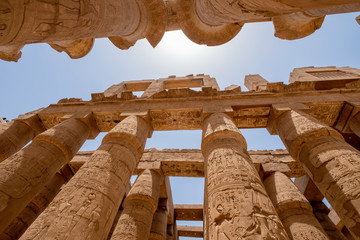 Mighty pillars with hieroglyphs in Great Hypostyle Hall at the Temples of Karnak (ancient Thebes),...