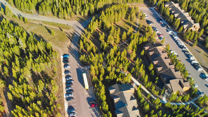 Aerial view of Yellowstone Lake with woods and car parking on a beautiful summer morning