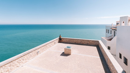 man looking at the sea from viewpoint in Peñiscola