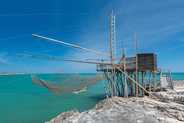 Fototapeta na wymiar Typical traditional fishing trabucco at the beach of Vieste along the Adriatic Sea in Puglia, Italy.