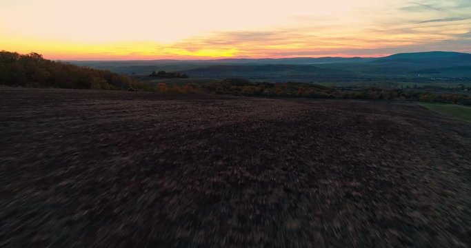 Autumn forest drone aerial shot at sunset. Overhead view of foliage trees in Hungary, Matra, Muzsla. Inspiring autumn season landscape panorama.