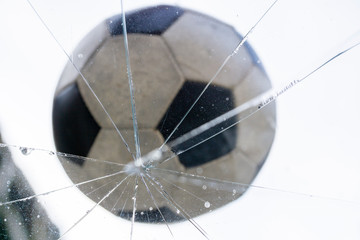 old small football which was shot in a glass