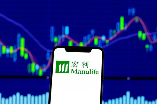 Manulife logo is seen on an smartphone over stock chart