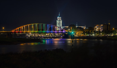 Fototapeta na wymiar Deventer bridge over river IJssel in rainbow colors on Coming Out Day