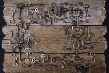 old vintage  keys  on wooden background concept