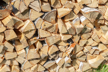 Dry chopped firewood lay in a pile on the street
