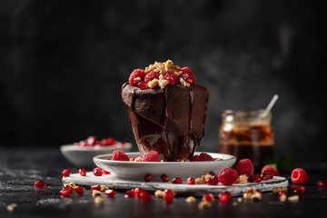Raspberry mug cake in a glass on dark background