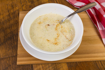 Overhead View of Bowl of She Crab Soup on Rustic Wood Table