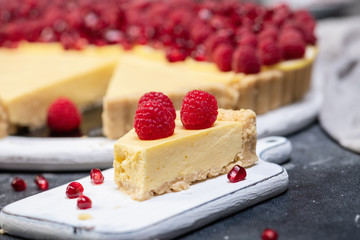 fresh french tart with raspberries on dark background