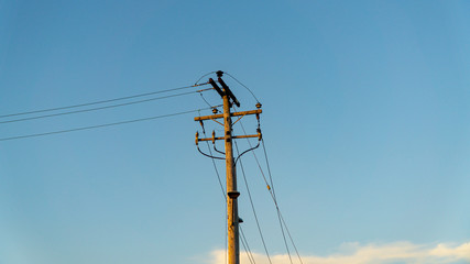 Electrical pole high voltage in white cloud and blue sky