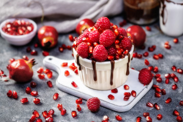 Raspberry mug cake in a red ceramic mug on dark background