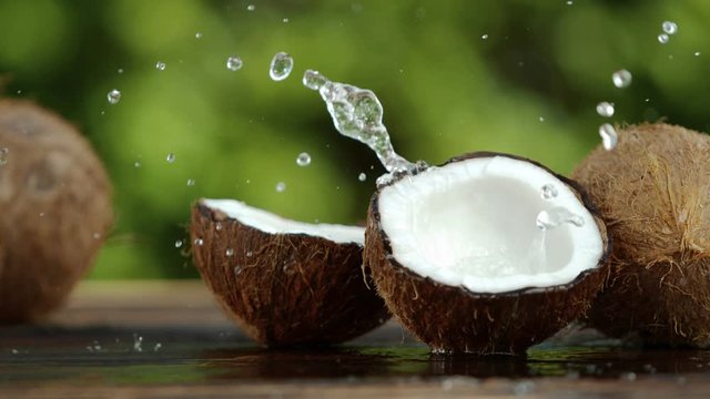 Super slow motion of coconut with splash, speed ramping effect. Filmed on high speed cinema camera, 1000 fps.