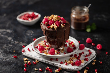 Raspberry mug cake in a glass on dark background