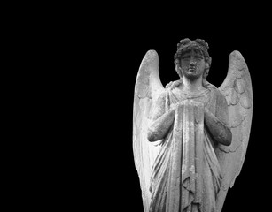 Death.  Ancient statue of angel isolated on black background as symbol of end of life.