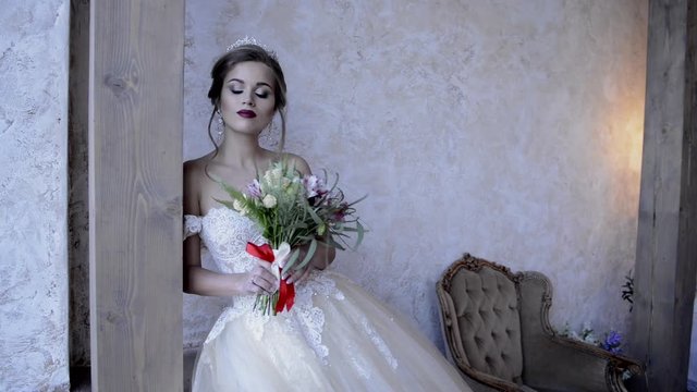 beautiful bride posing on camera in the interior