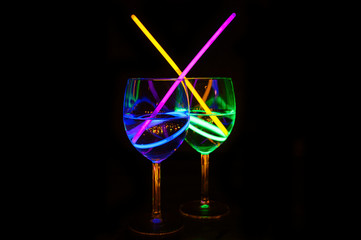 Delicious transparent tropical liquor cocktal in wine glass with dark background for party celebration, new year, bar and christmas with straw decor