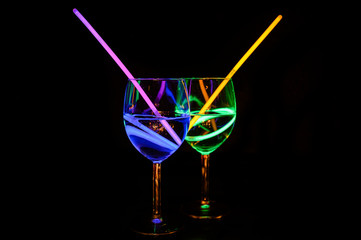 Exotic fresh alcoholic transparent beverages in wine glass with dark background for party celebration, new year, bar and christmas with straw