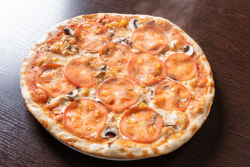 Cheap pizza with mushrooms, tomatoes, and corn.