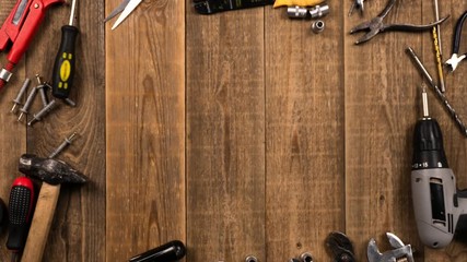 Hand tools on wooden table, logo intro animation stop motion. The concept of a set of tools for repair. Top view of hammer, screwdriver and other tool on wooden board for home craftsman.