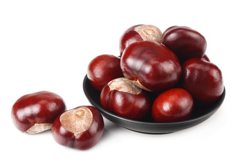 chestnuts in a black plate isolated on white background