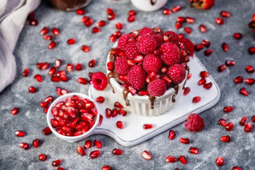 Raspberry mug cake in a white ceramic mug on dark background