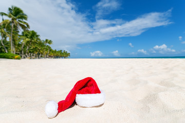 Fototapeta na wymiar Santa Claus hat on beach.