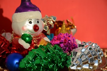 Multi-colored snowman and Christmas toys cones on a red background