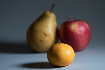 Ripe fruits on a gray background shot closeup.