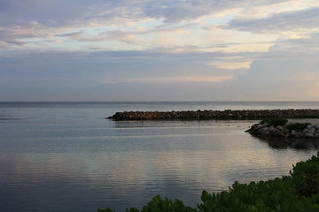 Looking along the coastline and out over the Caribbean sea, Ocho Rios, Jamaica. Early morning light, cloudy sky.