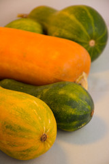  Harvest of large oblong pumpkins close-up on a light background
