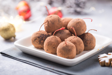Christmas Sweet candies on the dessert table . Balls of biscuit with cherry - loli pop or cake pop. New year decoration and apple cider drink. happy holidey concept