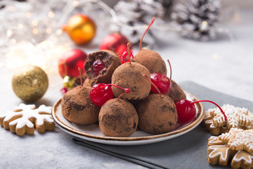 Christmas Sweet candies on the dessert table . Balls of biscuit with cherry - loli pop or cake pop. New year decoration and apple cider drink. happy holidey concept
