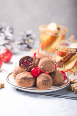 Christmas Sweet candies on the dessert table . Balls of biscuit with cherry - loli pop or cake pop. New year decoration and apple cider drink. happy holidey concept
