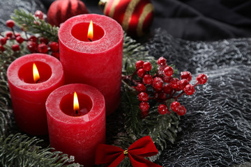 Christmas candles with red berries and fir tree branches