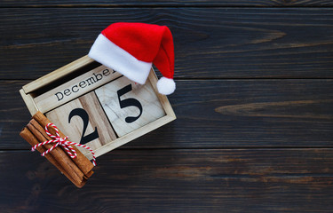 Wooden calendar on the table with 25 of December on it. Holidays and celebration concept, greeting...