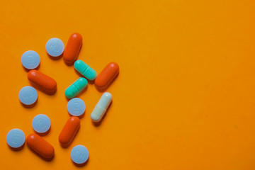 colorful medication and medicine pills, tablets and capsules. Isolated on office desk background. Medical or Healthcare concept