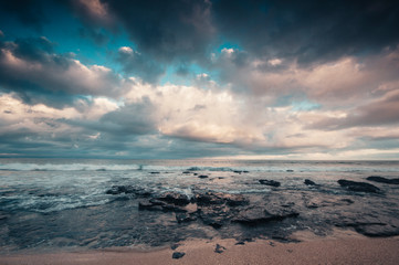 Jeffrey's bay  beach, beautiful dramtaic sunset, empty beach with moody filter applied to the image, lot of space in the sky to add text