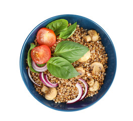 Bowl of buckwheat porridge with vegetables an mushrooms on white background, top view