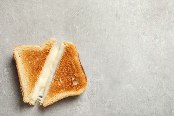 Fresh cheese sandwiches on grey table, top view. Space for text