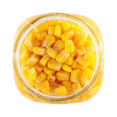 Open jar with pickled sweet corn on white background, top view