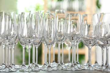 Empty glasses on wooden table against blurred background