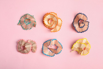 Pencil shavings on pink background, flat lay