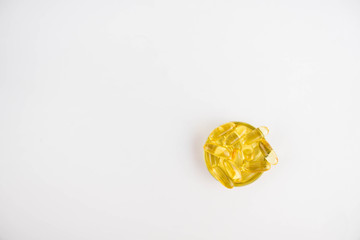 Omega 3 capsules lying in the lid on a white background. Copy space for text