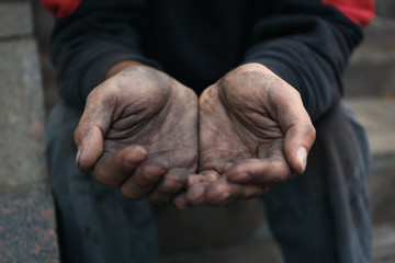 Poor homeless man begging for help outdoors, closeup