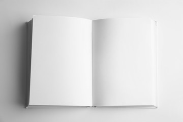 Open book with blank pages on white background, top view. Mock up for design