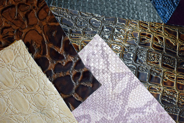 Faux leather in different colors with a crocodile skin texture. Materials for sewing bags and wallets made of artificial leather with texture. Pieces of fabric.