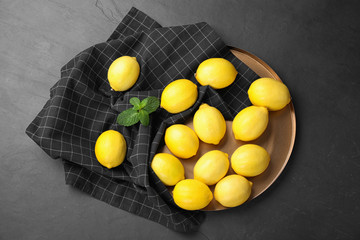 Fototapeta na wymiar Flat lay composition with fresh ripe lemons on dark table