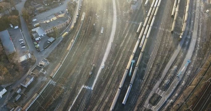 Railway depot with trains and passing locomotive. 4K video, 240fps, 2160p.